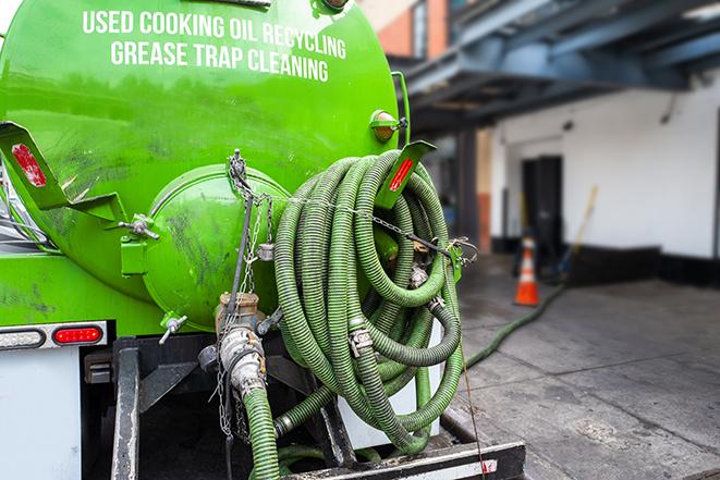 a technician pumping a grease trap in a commercial building in East Fishkill